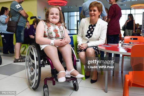 Scotland's First Minister Nicola Sturgeon poses for a photograph with 14-year-old Ella Chambers during a visit to the Royal Hospital for Children to...