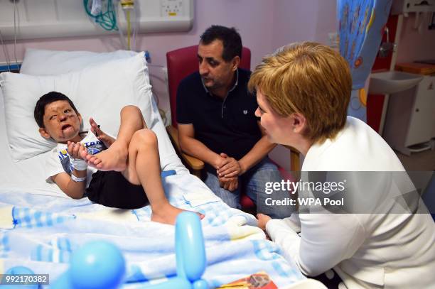 Scotland's First Minister Nicola Sturgeon meets with 4-year-old Mohammad Sudais and his uncle Mohammed Asif during a visit to the Royal Hospital for...