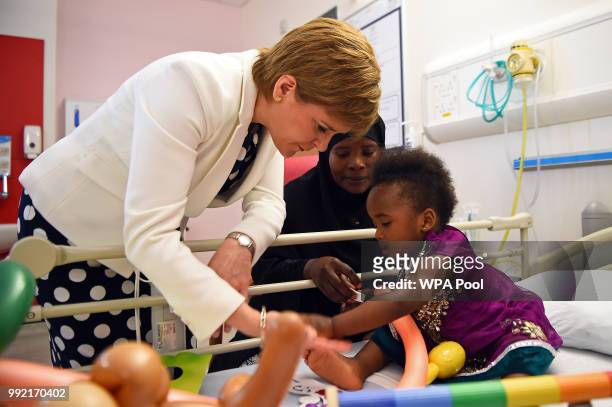 Scotland's First Minister Nicola Sturgeon meets with 20-month-old Hibatullah Kizito during a visit to the Royal Hospital for Children to mark the...