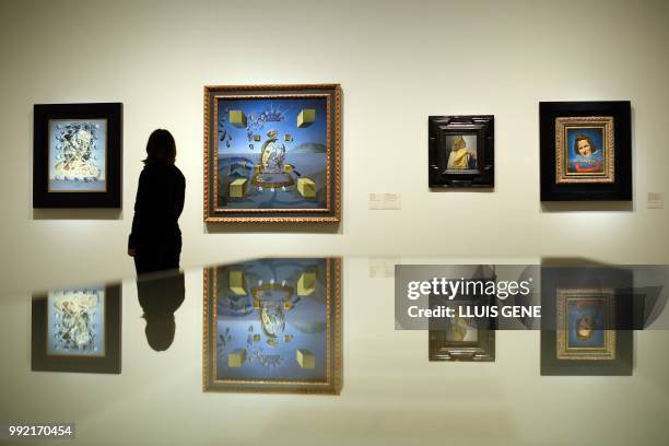 Visitor looks at the paintings "Gala Placidia,1952", "Galatea in creation, 1954", "Gala looking at the Hypercubic Christ, 1954" and "Portrait of Gala...