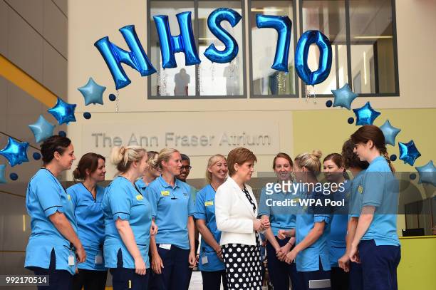 Scotland's First Minister Nicola Sturgeon speaks with members of staff during a visit to the Royal Hospital for Children to mark the 70th Anniversary...