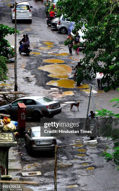 The recent heavy spell of showers has increased the problem of commuters as huge potholes have appeared on various roads in the city after rain at...