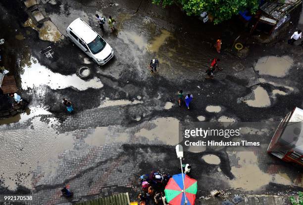 The recent heavy spell of showers has increased the problem of commuters as huge potholes have appeared on various roads in the city after rain at...