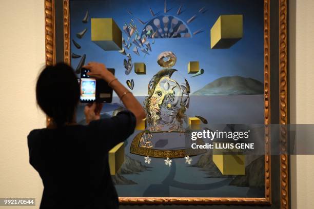 Visitor takes a picture with his smatphone at the painting "Galatea in creation, 1954" by artist Salvador Dali during the exhibition entitled "Gala...