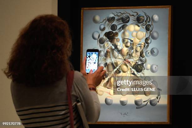 Visitor takes a picture with his smatphone at the painting "Gala Placidia,1952" by artist Salvador Dali during the exhibition entitled "Gala Salvador...