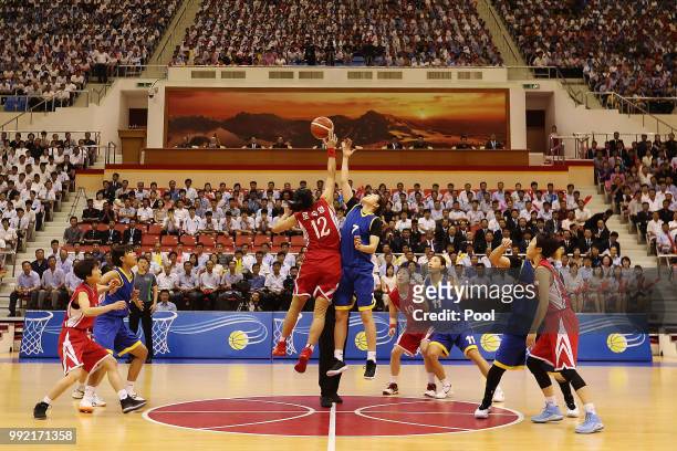 Mixed teams of North and South Korean basketball players take part during an inter-Korean basketball match at Ryugyong Chung Ju-yung Gymnasium on...