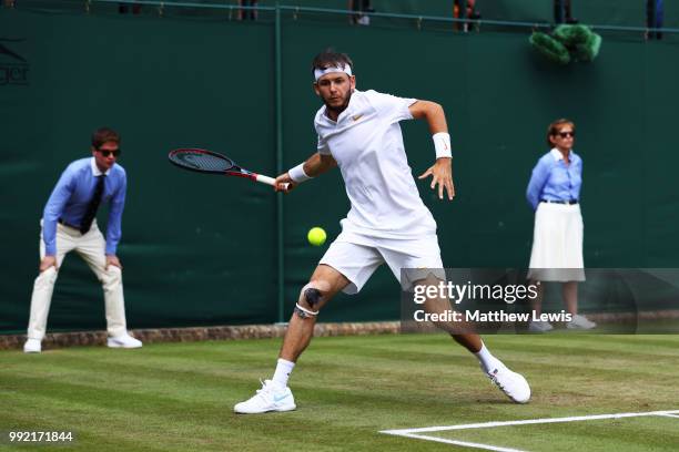 Jared Donaldson of the United States returns a shot against Stefanos Tsitsipas of Greece during their Men's Doubles first round match on day four of...