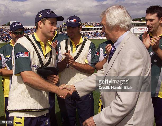 Simon Katich of Australia is presented with his baggy green cap by Ritchie Benaud, during day one of the fourth test between England and Australia at...