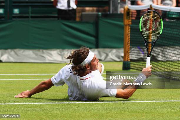 Stefanos Tsitsipas of Greece falls to the court in an attempt to return a shot against Jared Donaldson of the United States during their Men's...