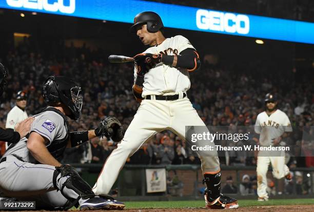 Gorkys Hernandez of the San Francisco Giants leans back out of he way of ball four forcing in Brandon Crawford with the go ahead run against the...