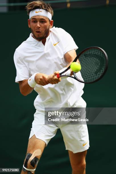 Jared Donaldson of the United States returns a shot against Stefanos Tsitsipas of Greece during their Men's Doubles first round match on day four of...