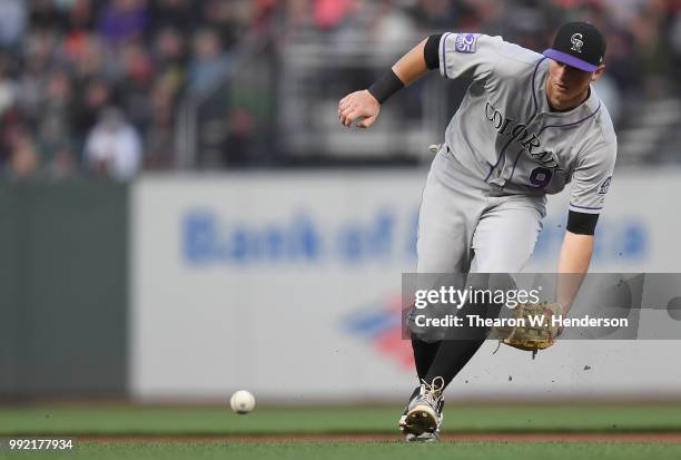 LeMahieu of the Colorado Rockies charges a ground ball off the bat of Derek Holland of the San Francisco Giants in the second inning at AT&T Park on...