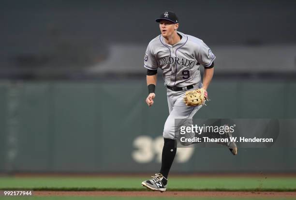 LeMahieu of the Colorado Rockies charges a ground ball off the bat of Derek Holland of the San Francisco Giants in the second inning at AT&T Park on...