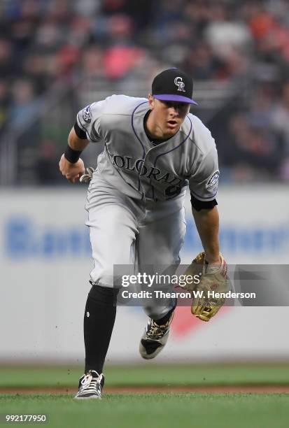 LeMahieu of the Colorado Rockies charges a ground ball off the bat of Derek Holland of the San Francisco Giants in the second inning at AT&T Park on...