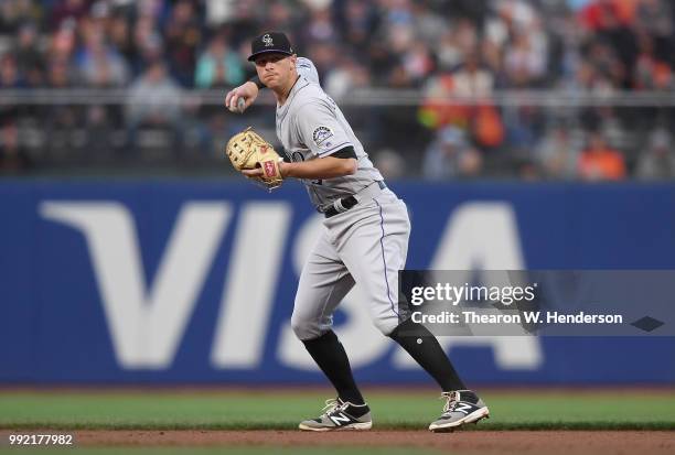 LeMahieu of the Colorado Rockies looks to throw the runner out at first base against the San Francisco Giants in the third inning at AT&T Park on...