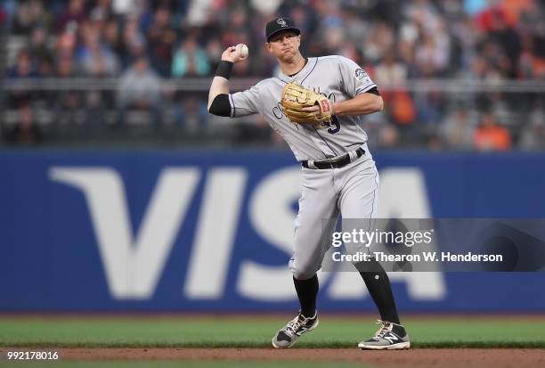 LeMahieu of the Colorado Rockies looks to throw the runner out at first base against the San Francisco Giants in the third inning at AT&T Park on...