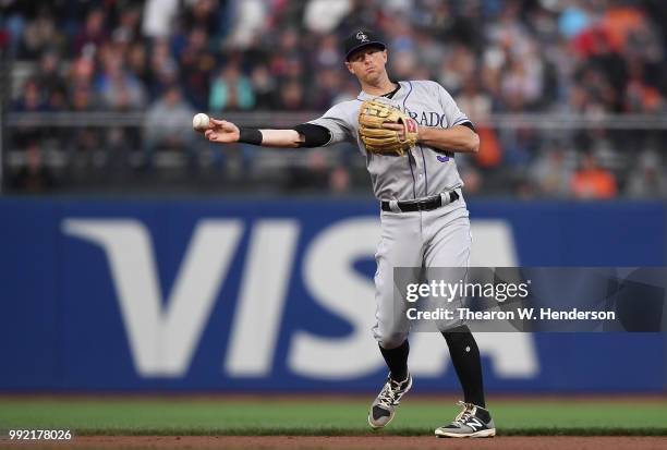 LeMahieu of the Colorado Rockies looks to throw the runner out at first base against the San Francisco Giants in the third inning at AT&T Park on...