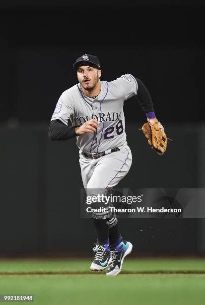 Nolan Arenado of the Colorado Rockies reacts by charging a ground ball against the San Francisco Giants in the seventh inning at AT&T Park on June...