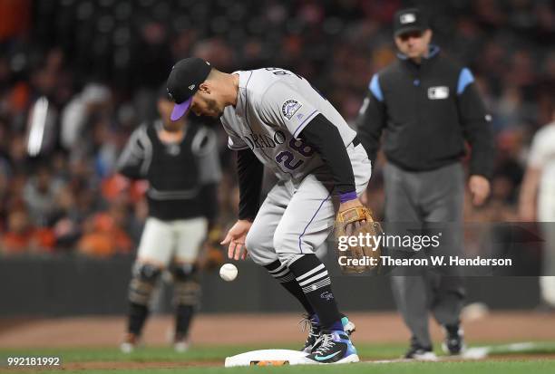 Nolan Arenado of the Colorado Rockies watches the ball hit off of third base for an infield single off the bat of Hunter Pence of the San Francisco...