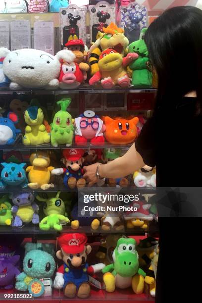 Pokemon's &quot;Pikachu&quot; and Nintendo's Super Mario stuffed toys are pictured at a shop in Tokyo, Japan, July 05, 2018.