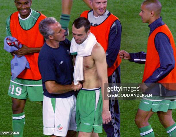 Irish coach Mick McCarthy congratulates his defender Gary Breen after winning the Group E first round match against Saudi Arabia counting for the...