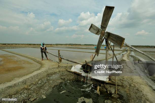 Farmers collect salt at one of the industrial salt centers in Mojowarno Village, Rembang, Central Java, July 5, 2018. The low productivity of the...