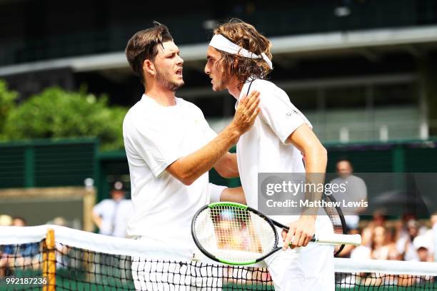 Stefanos Tsitsipas of Greece talks with Jared Donaldson of the United States after their Men's Doubles first round match on day four of the Wimbledon...