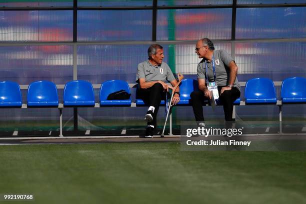 Oscar Tabarez, Head coach of Uruguay speaks to a member of his backroom staff during a training session at Sports Centre Borsky on July 5, 2018 in...