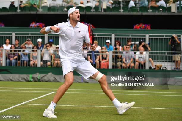 Player John Isner celebrates winning against Belgium's Ruben Bemelmans during their men's singles second round match on the fourth day of the 2018...