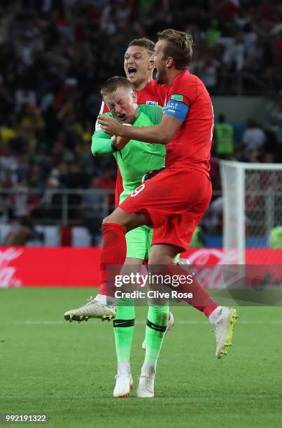 Jordan Pickford of England is mobbed by Harry Kane and Kieran Trippier in celebration after England win the penalty shootout following the 2018 FIFA...