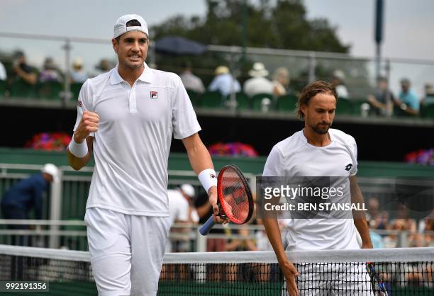 Player John Isner celebrates winning against Belgium's Ruben Bemelmans during their men's singles second round match on the fourth day of the 2018...
