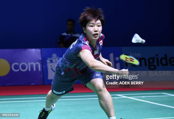 Akane Yamaguchi of Japan plays a return against Nozomi Okuhara of Japan during their women's singles badminton match at the Indonesia Open in Jakarta...