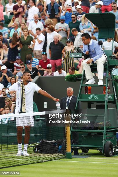 Nick Kyrgios of Australia argues a call with chair umpire James Keothavong during their Men's Singles second round match against Robin Haase of...
