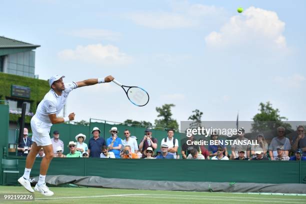 Luxembourg's Gilles Muller serves against Germany's Philipp Kohlschreiber during their men's singles second round match on the fourth day of the 2018...