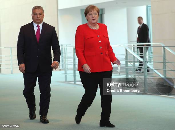 Viktor Orban, Hungary's prime minister, left, and Angela Merkel, Germany's chancellor, arrive for a news conference at the Chancellery in Berlin,...
