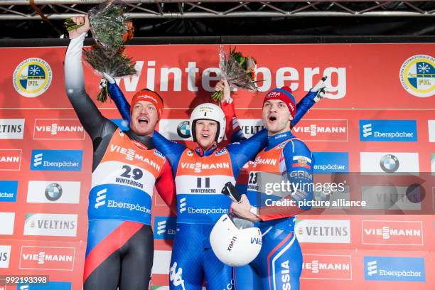 Felix Loch from Germany , Kevin Fischnaller from Italy and Stepan Fedorov from Russia celebrate after the Men's Singles event of the Luge World Cup...