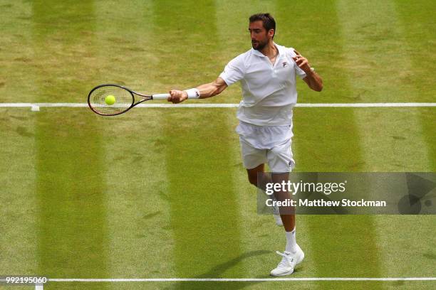 Marin Cilic of Croatia returns a shot against Guido Pella of Argentina during their Men's Singles second round match on day four of the Wimbledon...