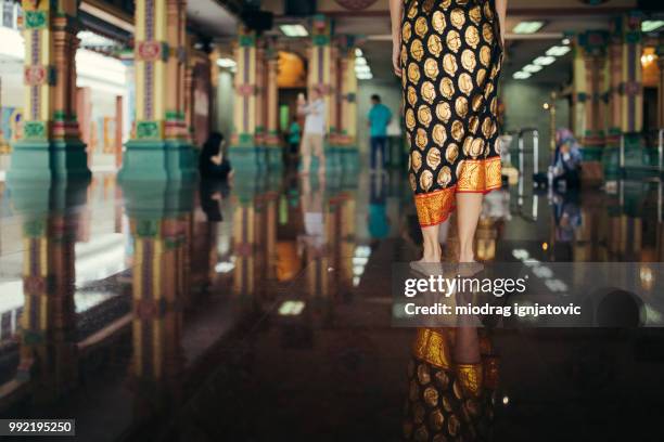 woman standing in the sri mahamariamman temple - sri mahamariamman temple stock pictures, royalty-free photos & images