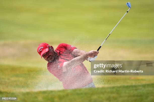 Thomas Bjorn of Denmark plays his second shot on the 1st hole during day one of the Dubai Duty Free Irish Open at Ballyliffin Golf Club on July 5,...