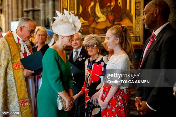 Britain's Sophie, Countess of Wessex, speaks with Freya Lewis, a survivor of the Manchester terror attack, at a service to celebrate the 70th...