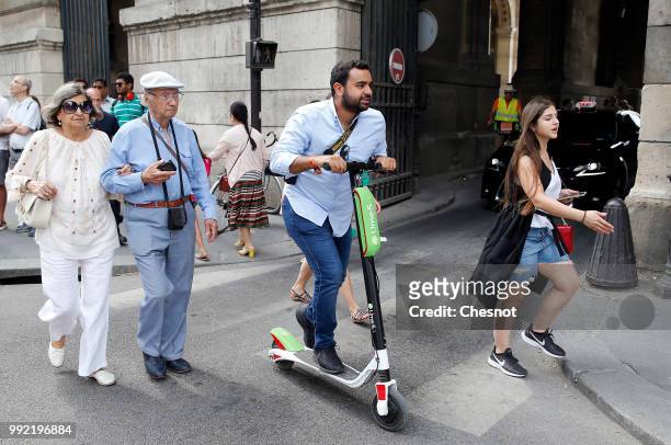 Man rides an electric scooter Lime-S from the bike sharing service company "Lime" on July 05, 2018 in Paris, France. The American start-up Lime,...