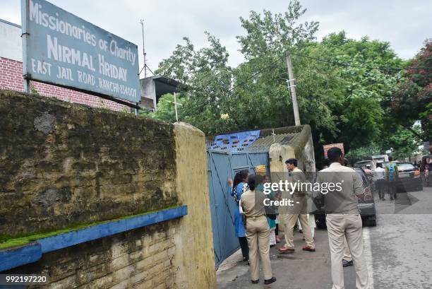 This photo taken on July 4, 2018 shows Indian police gathered outside the premises of Mother Teresa's Missionaries of Charity where a staff member...