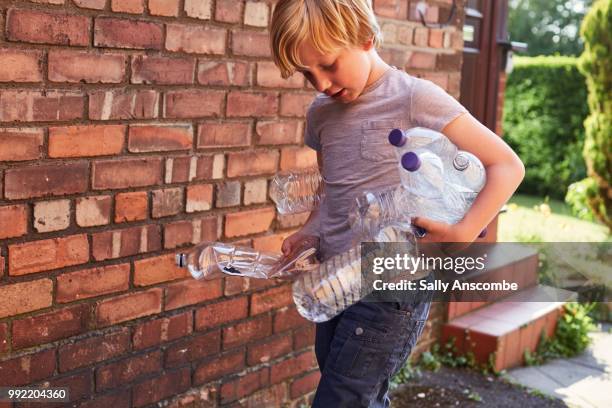 Child recycling plastic bottles