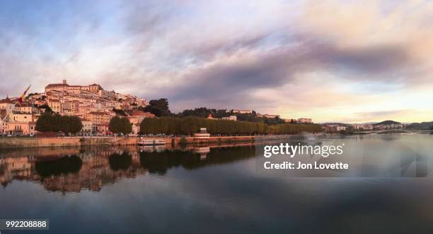 mondego river and coimbra city skyline at sunset - mondego stock pictures, royalty-free photos & images