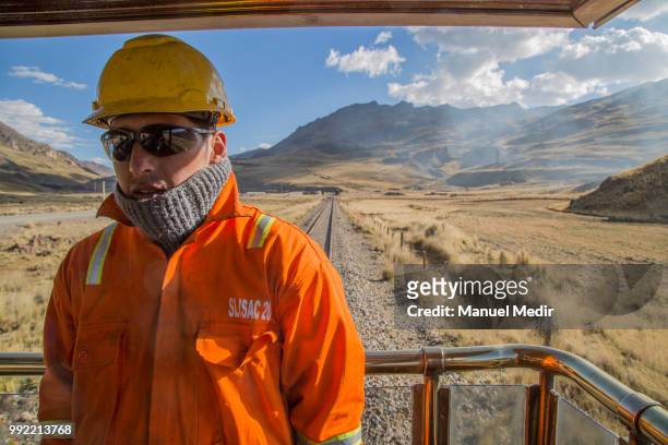 Worker looks on during a trip in the world famous Railroad 'Ferrocarril Central Andino' on June 29, 2018 in Lima, Peru. The Ferrocarril Central...