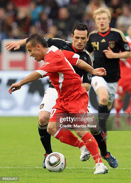 Piotr Trochowski of Germany and Andrew Cohen of Malta compete fot the ball during the international friendly match between Germany and Malta at...