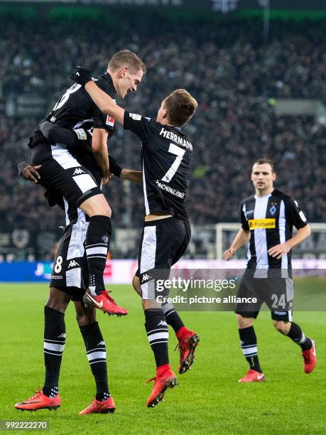 Gladbach's Matthias Ginter cheers over his 2-0 score with teammates Denis Zakaria, Patrick Herrmann and Corentin Tolisso during the German Bundesliga...