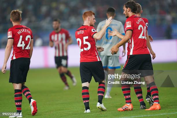 Harrison Reed of Southampton is congratulated by his team mates after scoring during the 2018 Clubs Super Cup match between Schalke and Southampton...