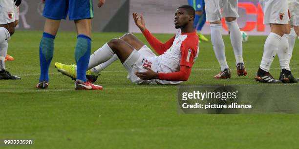 Augsburg's Kevin Danso lies on the ground during the German Bundeliga soccer match between FC Augsburg and VfL Wolfsburg in Augsburg, Germany, 25...