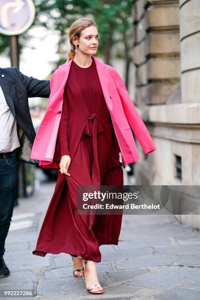 Natalia Vodianova wears a pink blazer jacket, a burgundy red dress, outside Valentino, during Paris Fashion Week Haute Couture Fall Winter 2018/2019,...